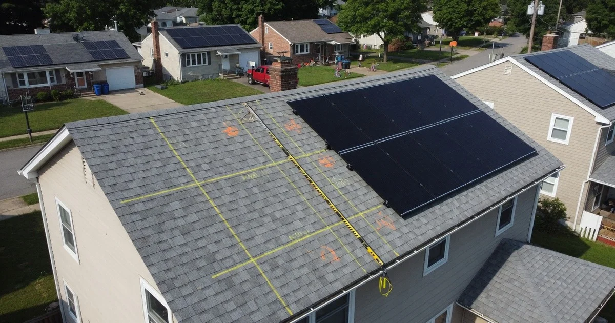 Aerial view of a house roof with partial solar array and chalk layout marks for system sizing